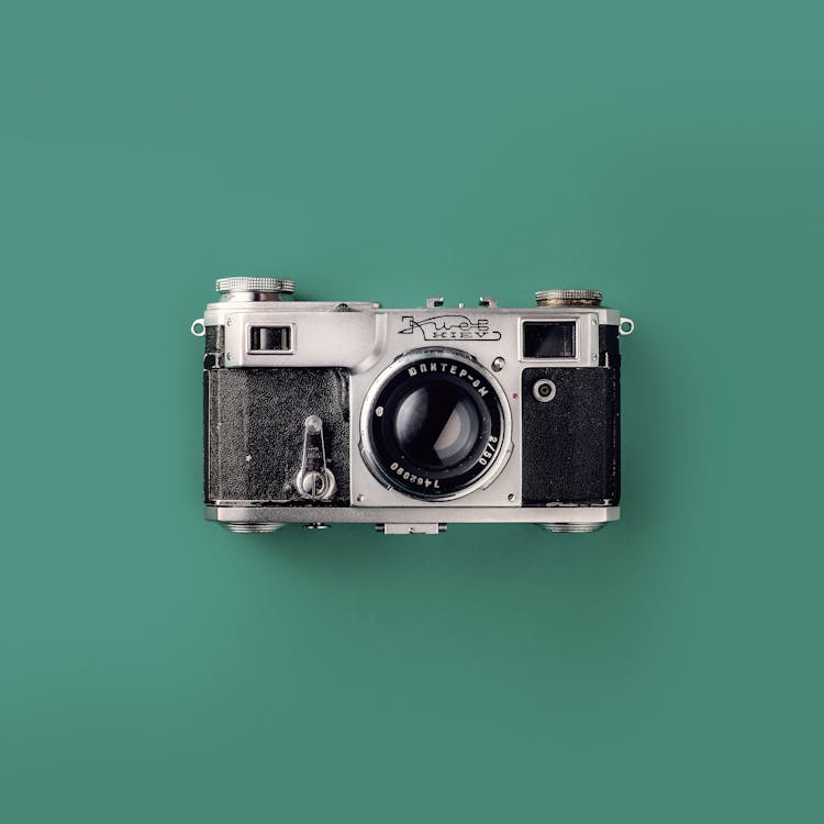 Free Grey and Black Camera On Green Background Stock Photo