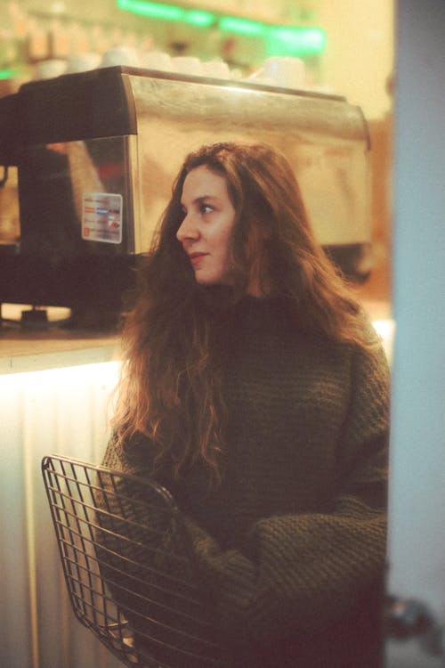 Woman in Sweater Sitting on Chair