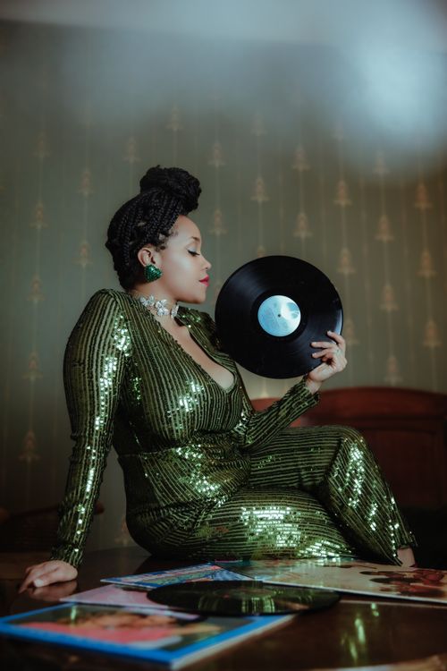Model in Green Clothes Sitting with Vinyl Disk Free Stock Photo Model in Green Clothes Sitting with Vinyl Disk Free Stock Photo