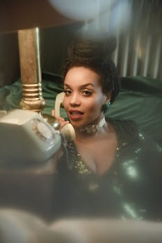 Stylish portrait of a woman with a retro phone, exuding vintage glamour.