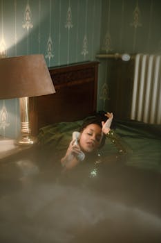 A woman in a vintage-themed bedroom talking on a retro telephone, exuding a nostalgic vibe.