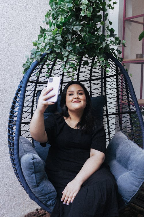 Brunette Woman Taking Selfie on Swing