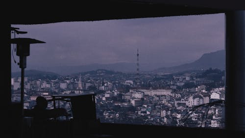 Silhouetted Interior with a Large Window with a Panoramic View of a City