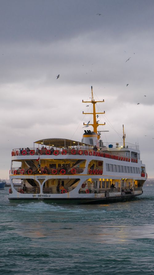 Free A ferry boat cruises the Bosporus in Istanbul under dramatic stormy skies. Stock Photo