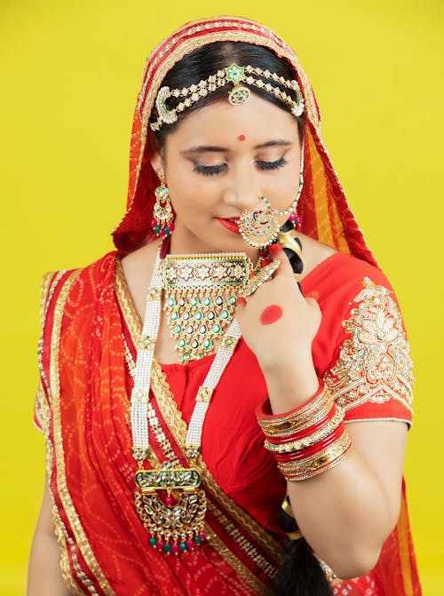 Free A woman in traditional indian attire with a gold necklace Stock Photo
