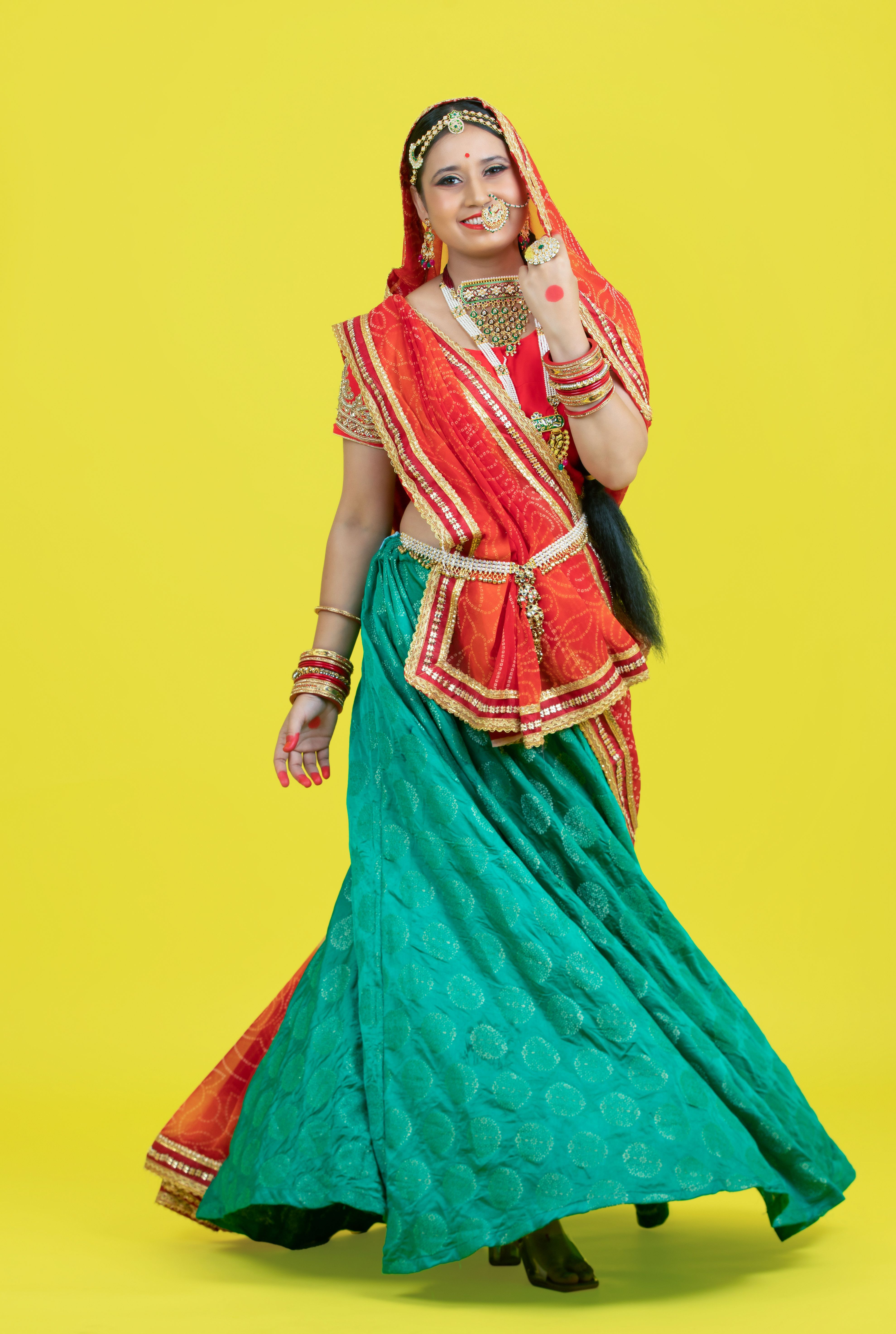 A woman in traditional indian dress posing for the camera · Free Stock ...