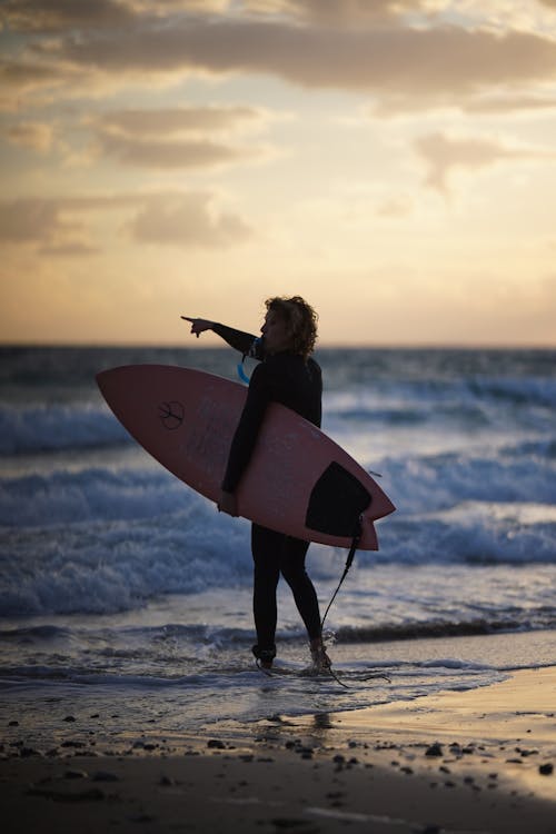 Surfer Standing on Beach