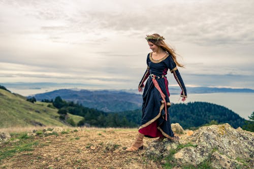 Woman in Traditional Dress on Hill