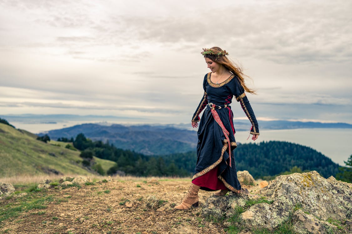 Woman in Traditional Dress on Hill