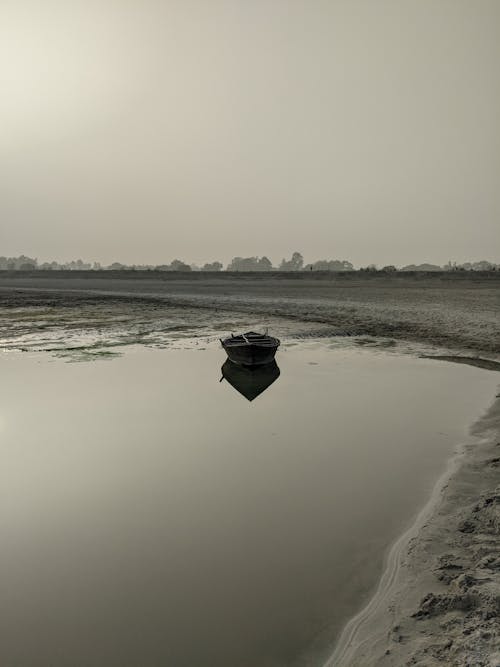 Boat Reflecting in lake at Dawn