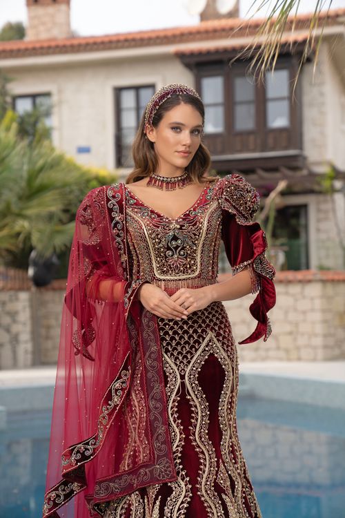 Free Portrait of a woman in traditional Turkish attire with intricate patterns, outdoors in İzmir. Stock Photo