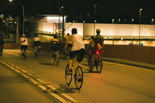 Cyclists on Street at Night