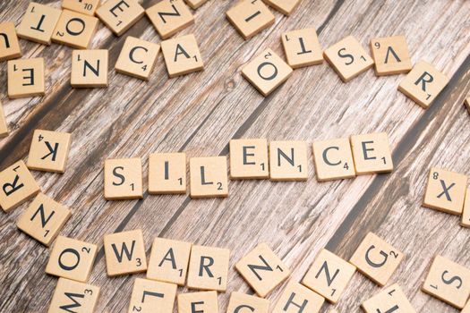The word silence spelled out in scrabble letters