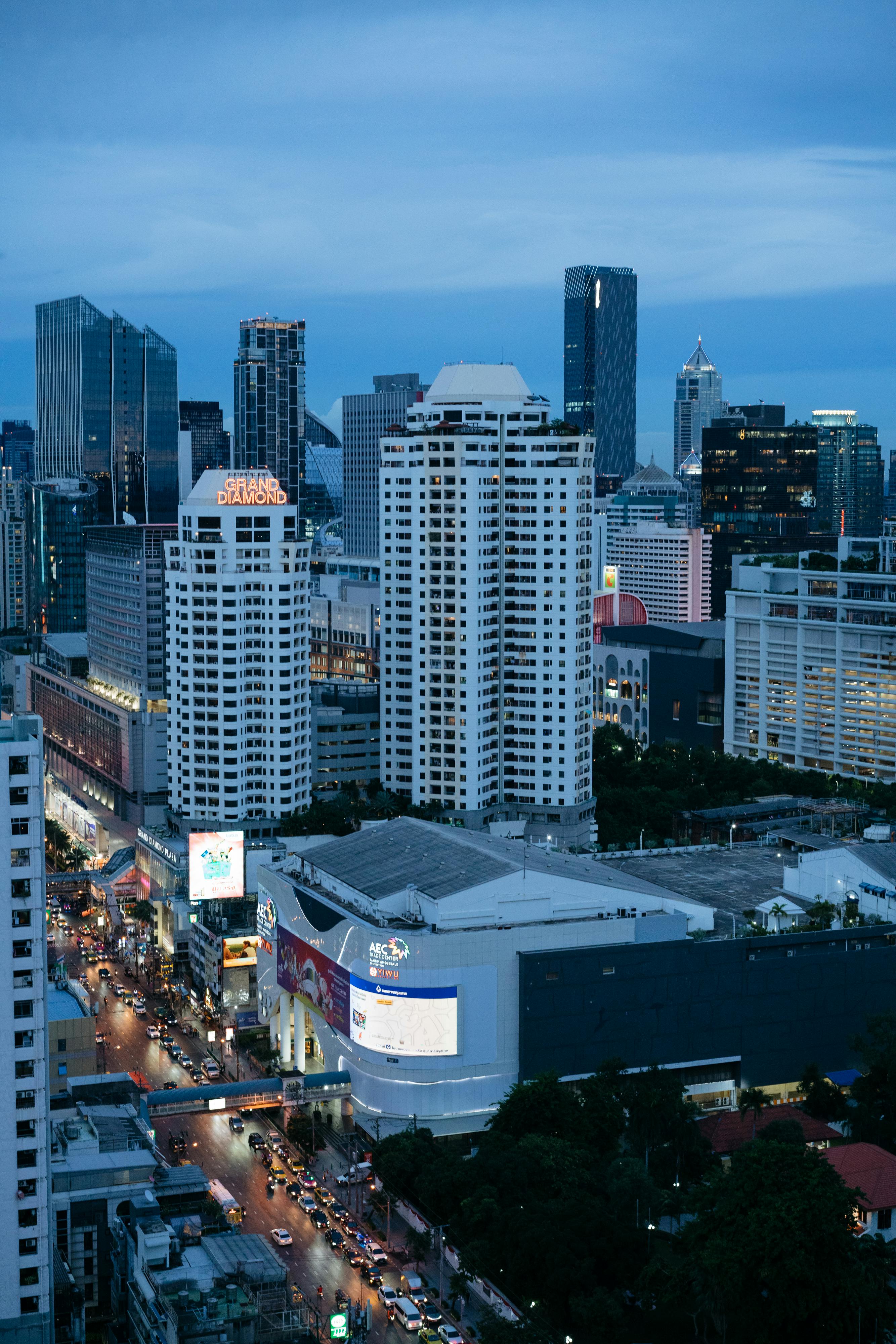 Discover the bustling skyline of Bangkok as it glows at twilight, showcasing modern skyscrapers and vibrant city lights.