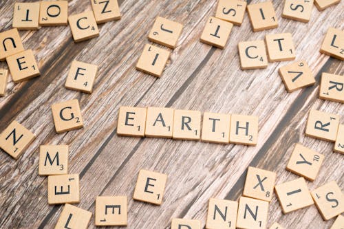 Earth made of scrabble letters on a wooden table