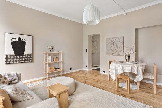 Bright neutral living room with a shelf and low table. Photo by Lisa Anna on Pexels