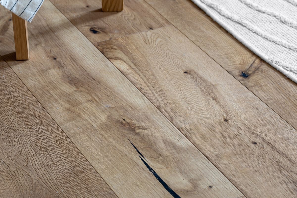 Detailed herringbone wood flooring pattern with natural tones