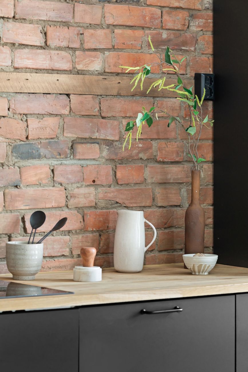 A kitchen with brick, timber and soft ceramics proves earthy colour is often about materials before paint.