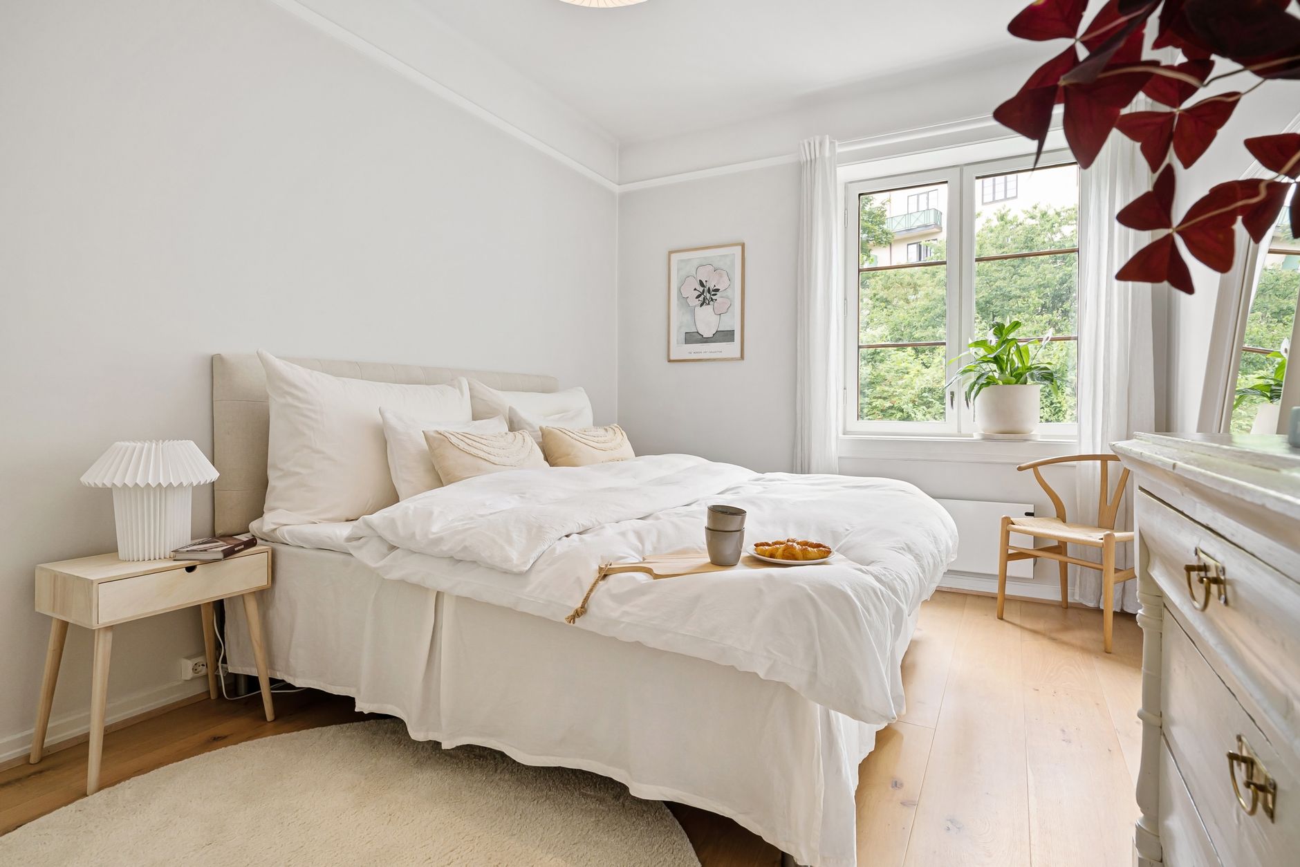 calm bedroom with oak bed and morning light