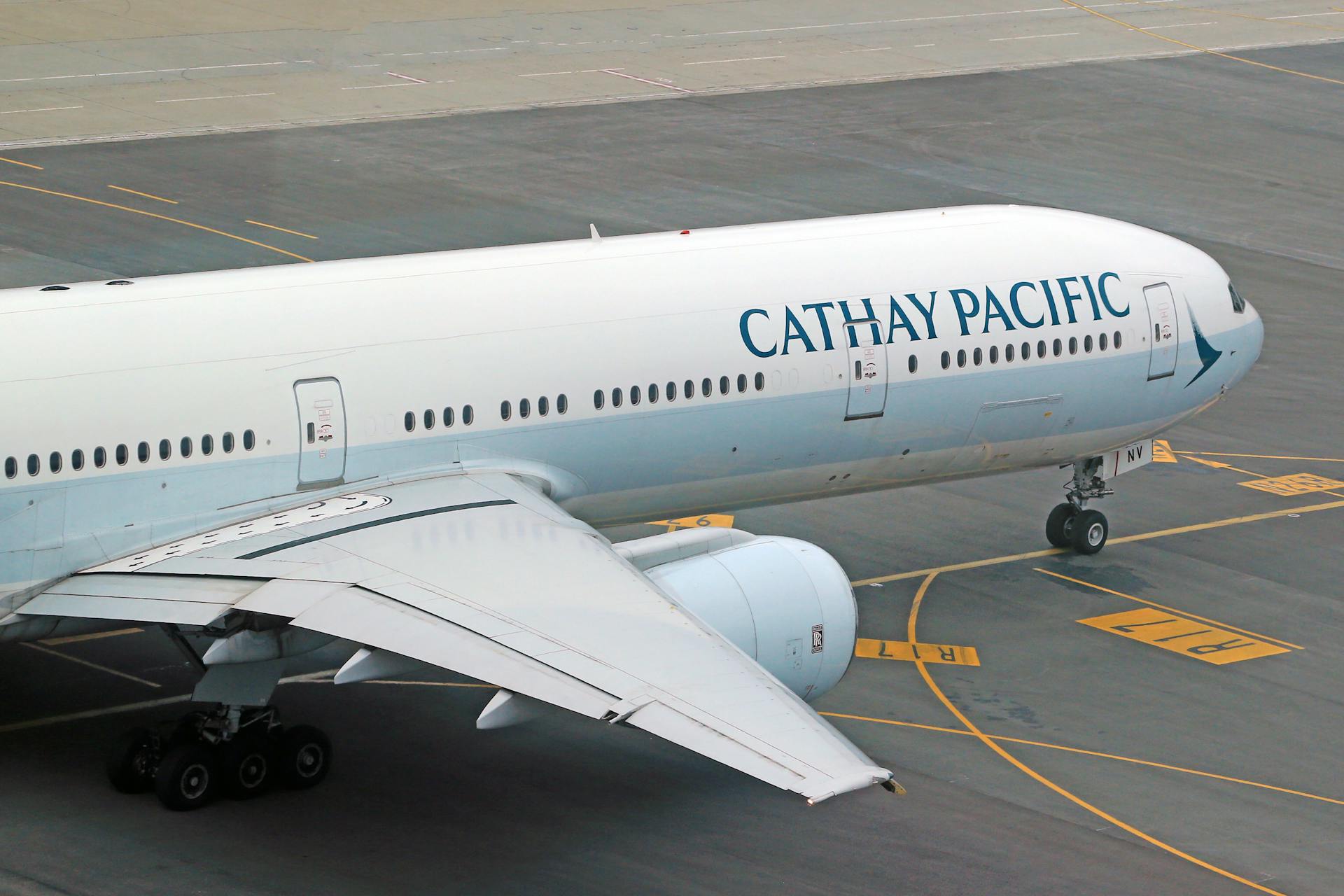 Cathay Pacific Boeing 777 taxiing on airport runway.