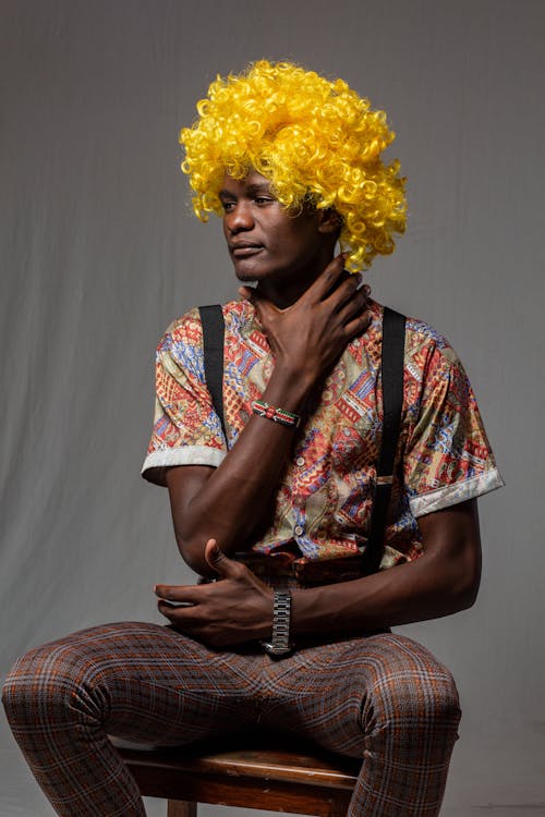 Man Sitting in Yellow Wig