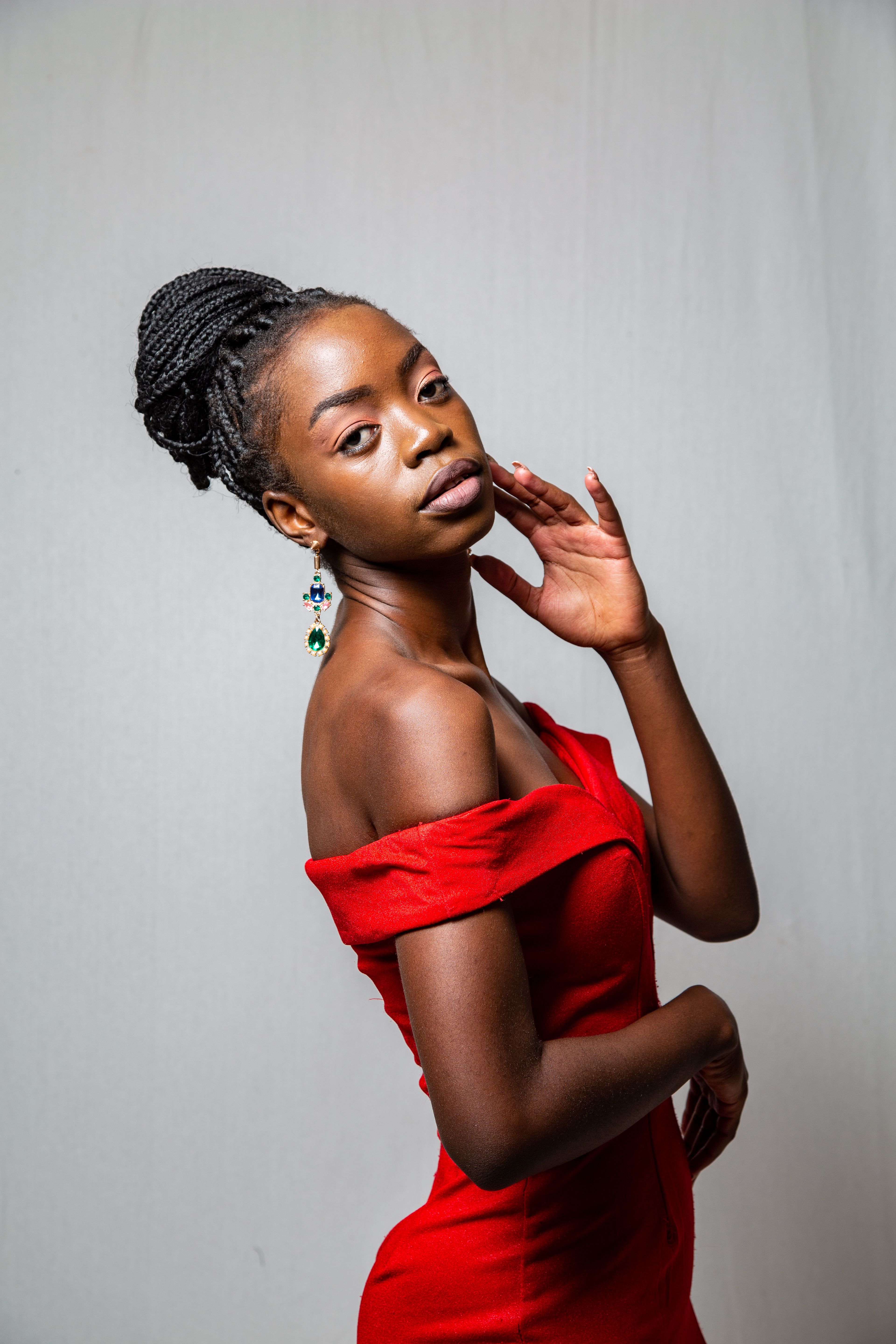 A beautiful woman in a red dress posing for the camera · Free Stock Photo