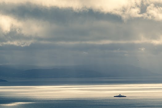Tranquil seascape of Trondheim, Norway, featuring a ferry under a dramatic sky.