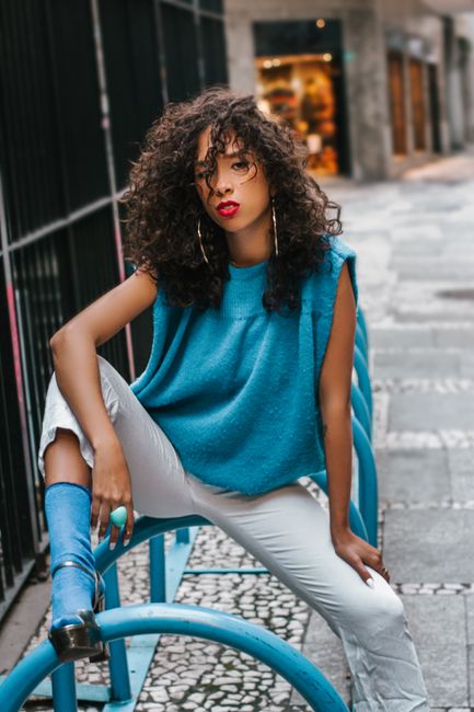 Discover modern urban fashion with a stylish model posing outdoors in vibrant attire.