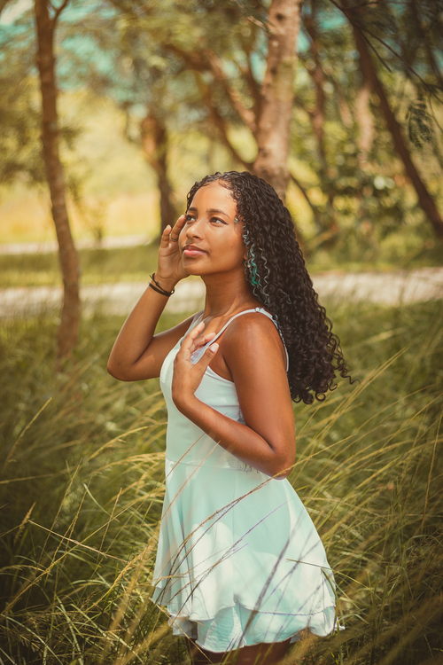 Young Woman in a White Dress Standing in a Park · Free Stock Photo