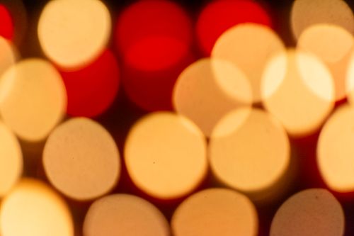 Free Abstract bokeh background with warm yellow and red blurred lights. Stock Photo