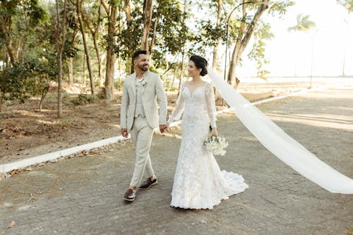 Newlyweds Holding Hands and Walking Together