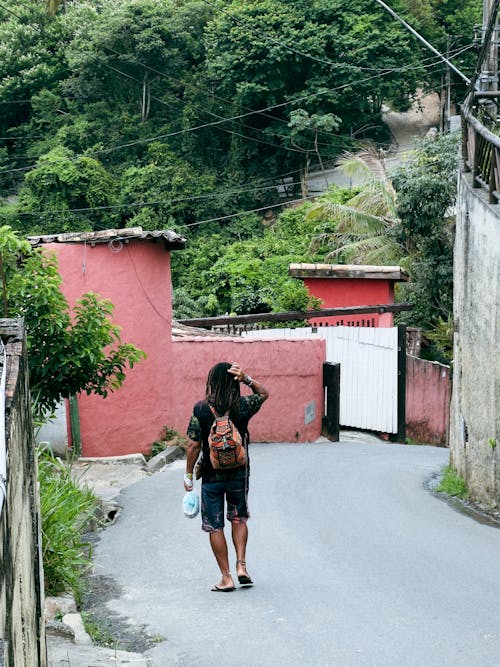 Man with Backpack Walking on Road in Ilhabela, Brazil