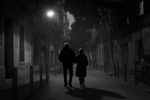 Couple Walking on Street at Night