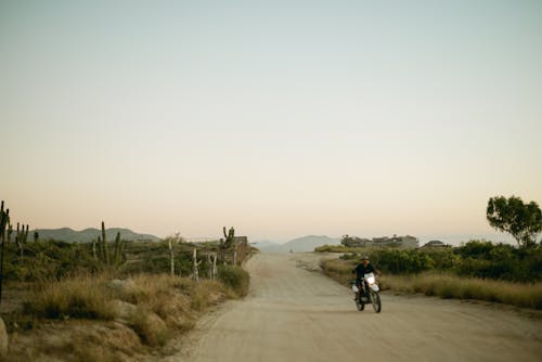 Man Riding Motorcycle in Countryside