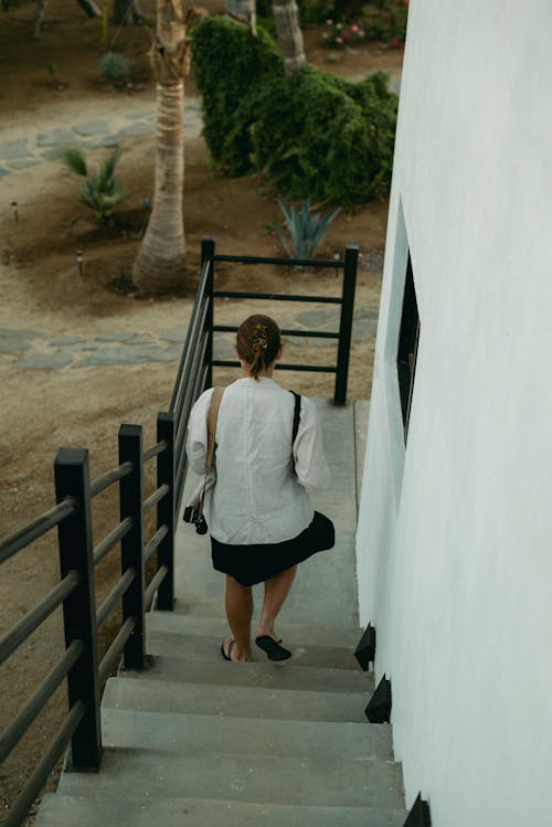 A woman walking down a set of stairs