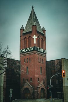 Calvary Temple Church tower in Winnipeg featuring Gothic architecture and a prominent cross.