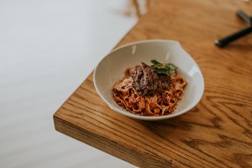 Meat on Noodles in White Bowl