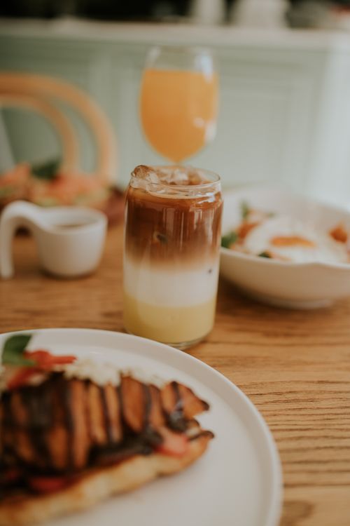 Free A beautifully set brunch table featuring iced coffee, pastries, and a refreshing beverage. Stock Photo