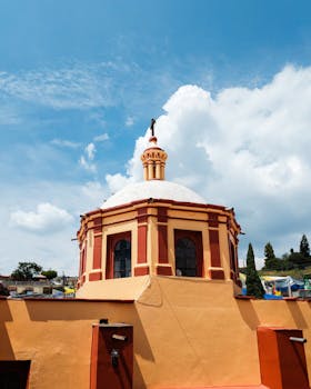 Vibrant dome of San Miguel del Milagro Church in Tlaxcala, Mexico under a clear blue sky.