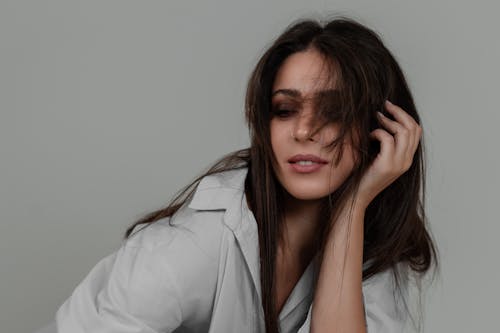 Studio Shoot of a Brunette Wearing a Shirt and Dark Eye Shadows