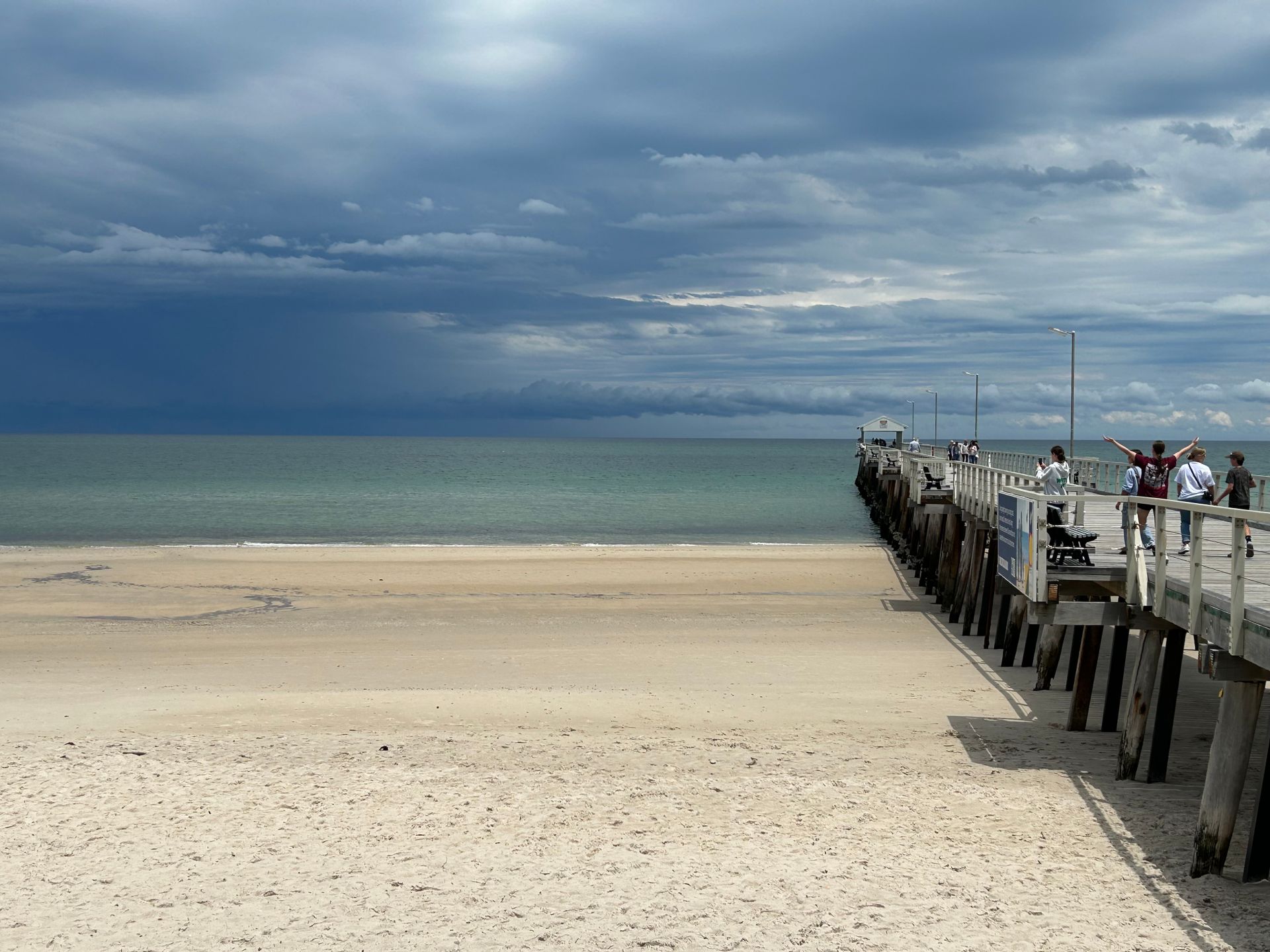 Experience a serene cloudy day at Henley Beach Pier with scenic views and tranquil seashore.