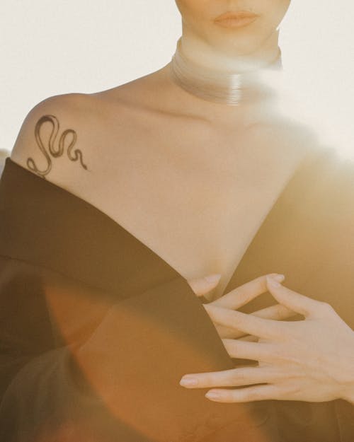 Free Woman Uncover Shoulder with Tattooed Snake Stock Photo