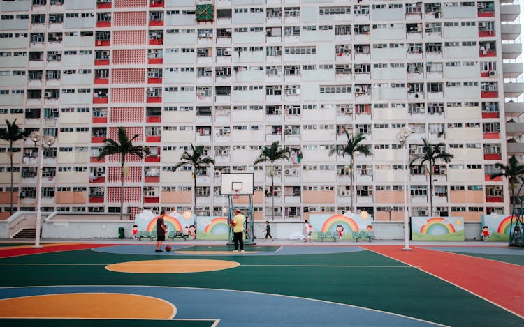 Colored Basketball Court Beside Block Of Flats