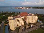 Aerial photograph of a prominent hotel by the seaside in Apia, Samoa.