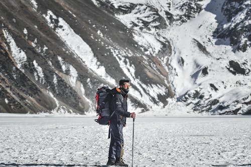 Man in a Mountain Valley Covered with Snow 