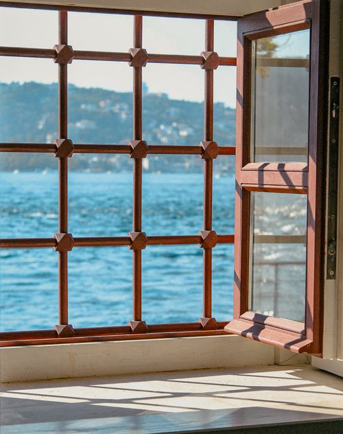 Free Sunlit open window with metal security bars facing the Bosphorus Strait in Istanbul, Turkey. Stock Photo