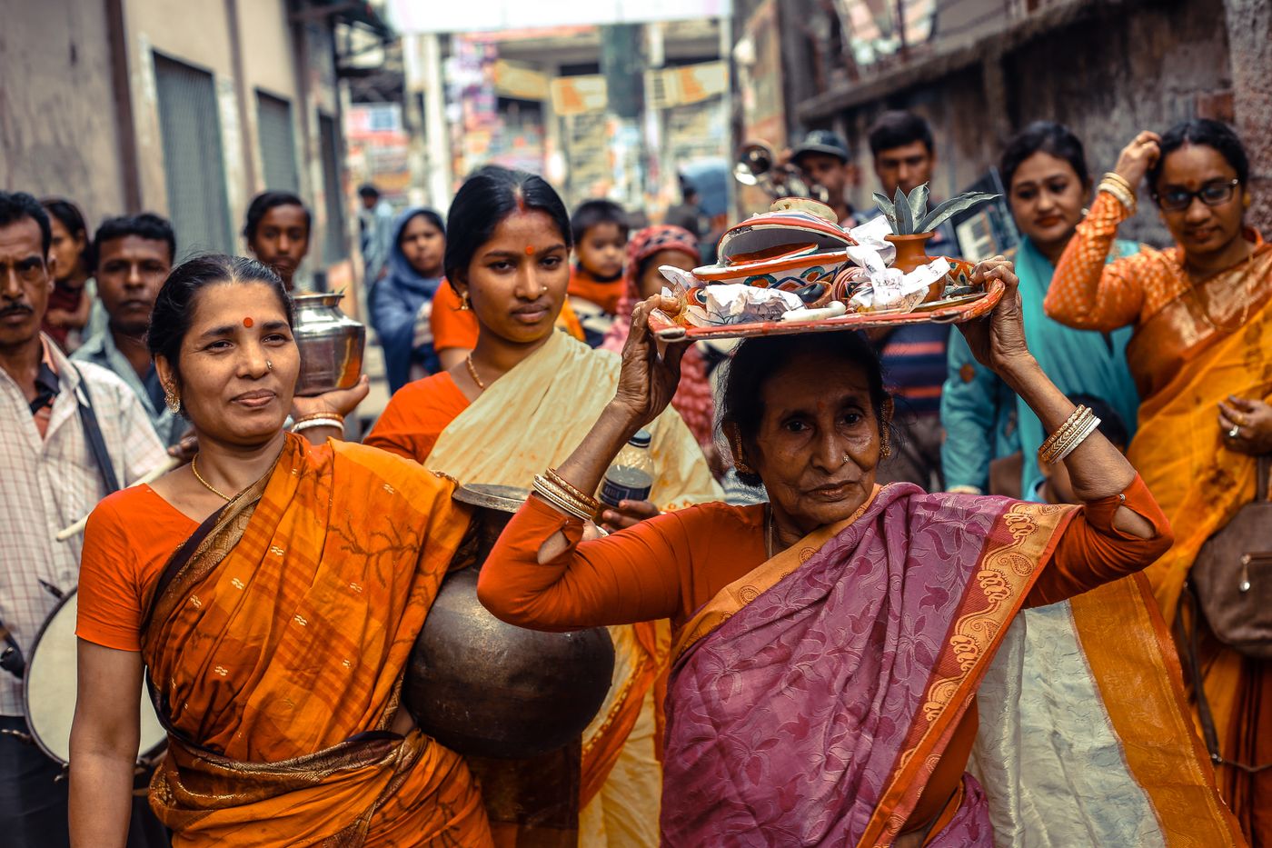 Indian women walking together in a community gathering, conveying warmth, participation, and local connection.