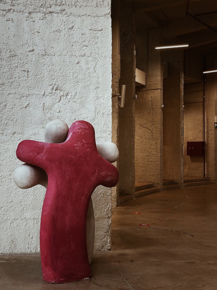 White And Red Statue On Pavement