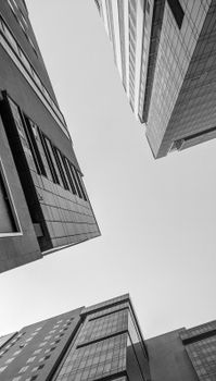 Low angle view of contemporary city buildings under a clear sky.