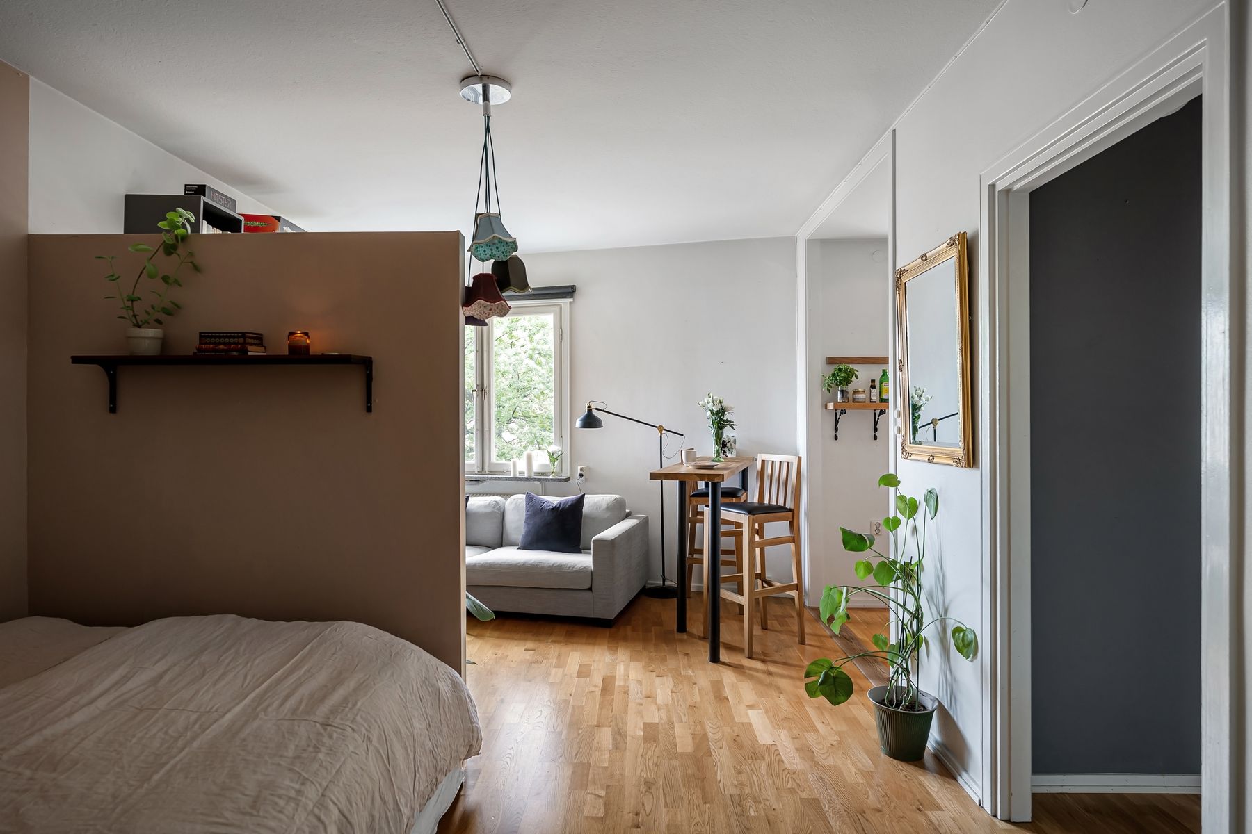 Compact studio apartment with coordinated sofa, dining and kitchen areas
